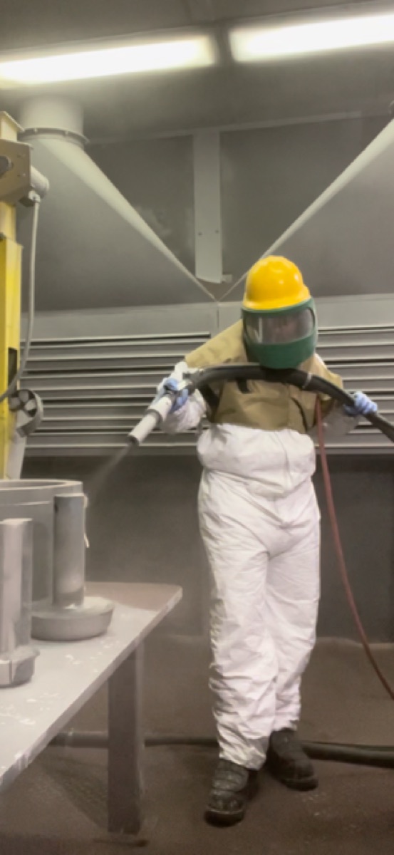 Lauren Session carrying out surface preparation work in full protective equipment