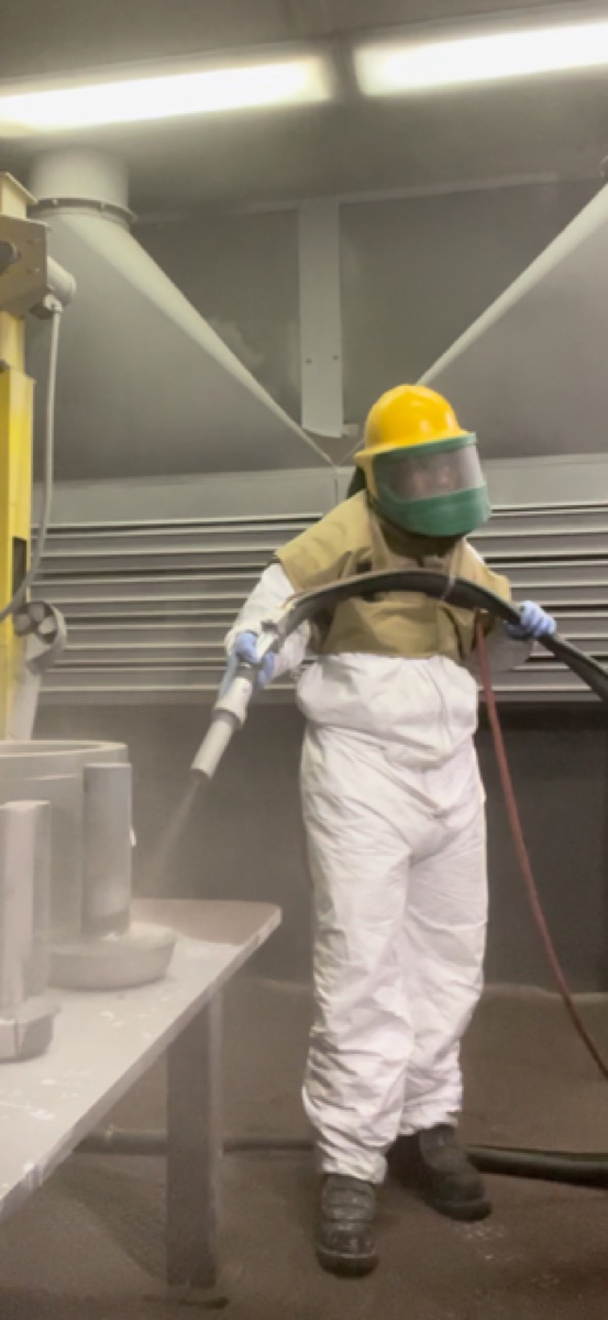 Lauren Session wearing full protective equipment while performing surface preparation